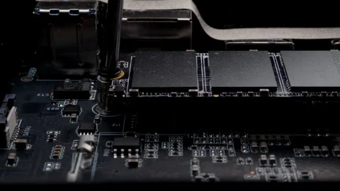 Screwing MSATA nvme M2 with a screwdriver for connecting fast modern SSD Stock Footage 263477949