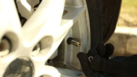 Screwing up nipple plug to wheel after pumping up Stock Footage 130648740