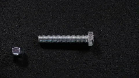Screwing nut on bolt Stock Footage 71227538