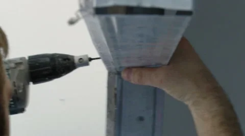 Screwing in a plaster board on a construction Stock Footage 55862570