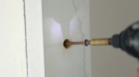 Screwing a screw into a hole with a power drill Stock Footage 46595176