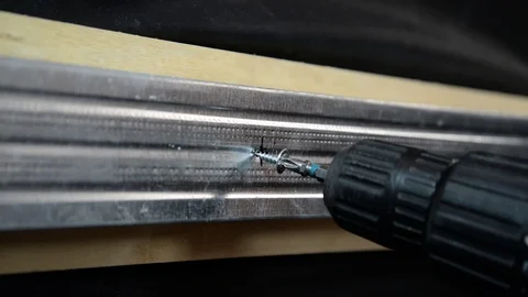 Screwing the screw into the metal surface Stock Footage 104125521
