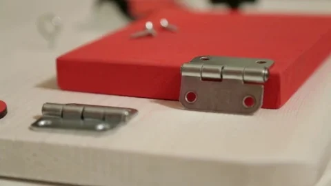Screwing a screw into wood.Installation hinge Stock Footage 69867796