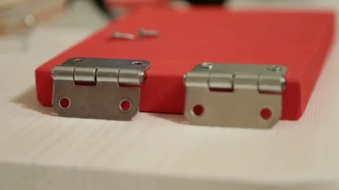 Screwing a screw into wood.Installation hinge Video stock 69868022