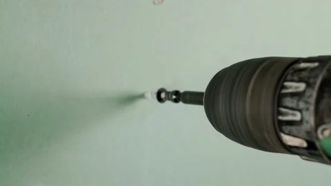 Screwing a self-tapping screw into a drywall wall. Stock Footage 150395969