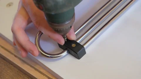 Screwing a self-tapping screw with a screwdriver close-up. The guy is screwing a Stock Footage 220881569