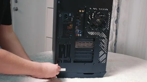 Screwing in side panel screws of desktop computer case Stock Footage 328981132