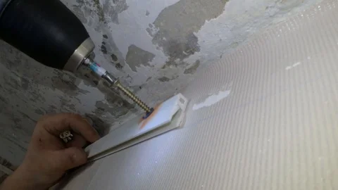 Screwing to the wall under the stretched ceiling Stock Footage 88485267