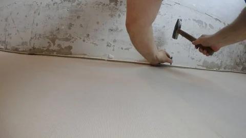 Screwing to the wall under the stretched ceiling Stock Footage 88485273