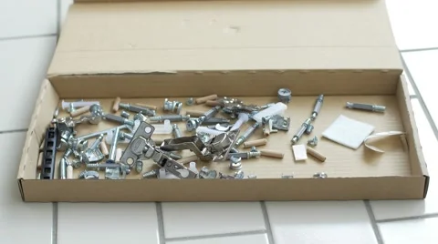 Screws and bolts close up rack focus- flat pack furniture Stock Footage 56071076