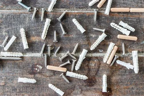Screws and plastic and wooden wall plugs on wooden background. The instrume.. Stock Photos
