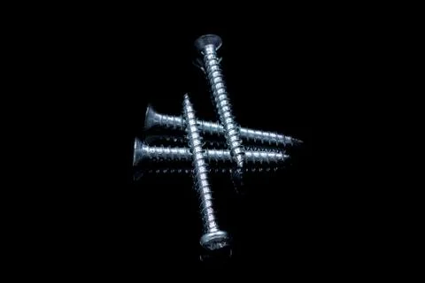 Screws on a black background with reflections Stock-Fotos