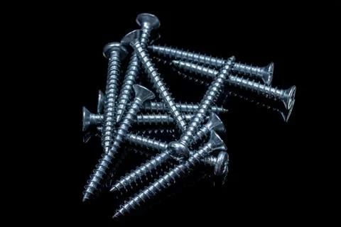 Screws on a black background with reflections Foto stock