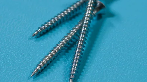 Screws on a blue background Stock Footage 99833335