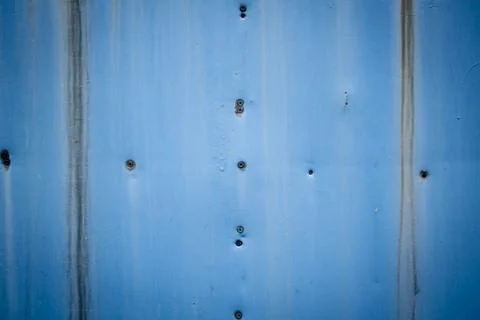 Screws on a blue rusty background Stock Photos