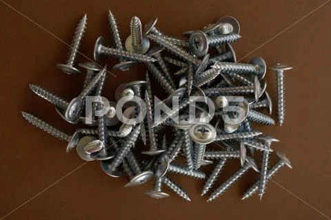 Screws on a brown background Stock Photos