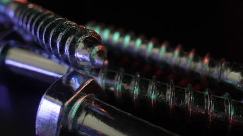Screws with chrome coating are located on the table in random order. The concept Stock Footage 160566261