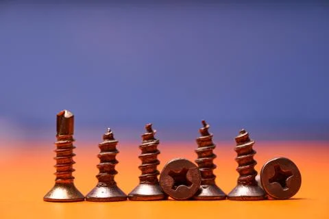 Screws close-up on a colored background. Fastening element Stock Photos