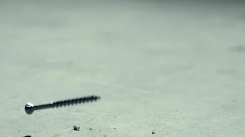 Screws falling to the ground high speed slow motion Stock Footage 58129797