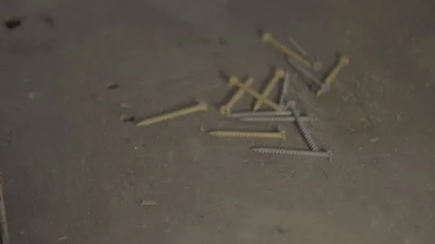 Screws falling on wood workbench Stock Footage 328941438