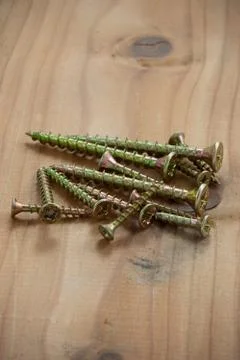 Screws on a floorboard Stock Photos