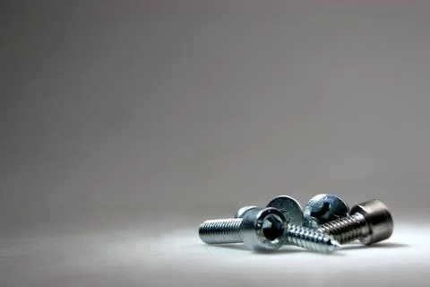 Screws on a grey background Stock Photos