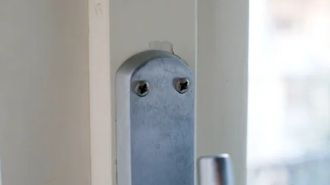 Screws of a handle inserted incorrectly in the window Stock Footage 126655363