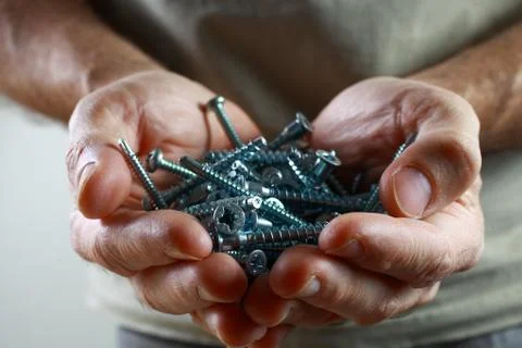 Screws in hands Stock Photos