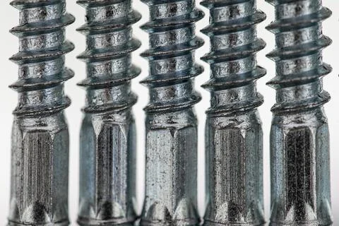 Screws with hexagonal shaft in a row of five. Close up Stock Photos