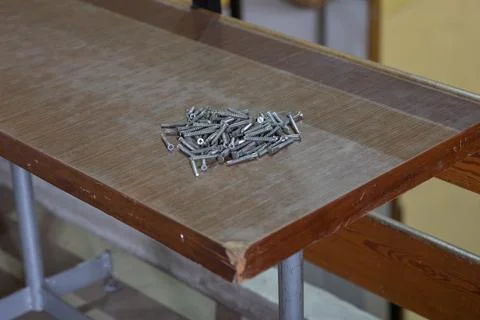 Screws lying on an old dusty table Stock Photos