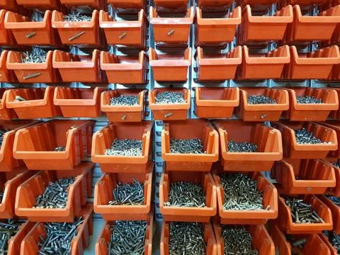 Screws in orange storage boxes in a workshop Stock-Fotos