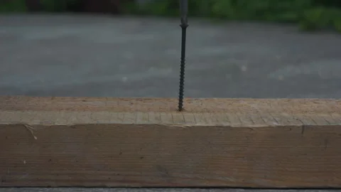 Screws the screw into the board Video stock 131258997