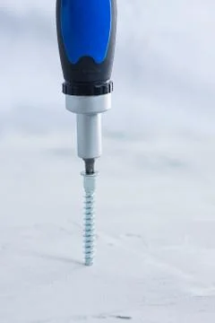 Screws with a screwdriver Stock Photos