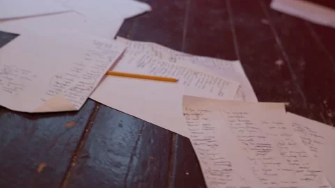 Scribbled on A4 paper, sheets lie on the old wooden floor. Stock Footage 161261508