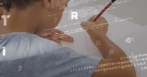 Scribbling boy writing on notebook at white desk, with red pencil and code 스톡 사진