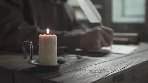 Scribe putting out a candle flame with a metal snuffer tool Stock Footage 340079685
