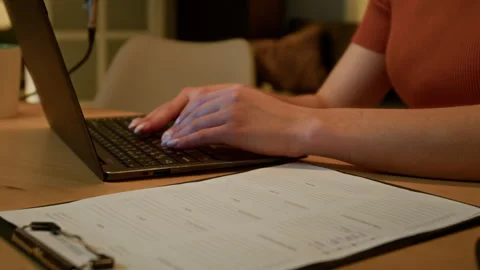 Script on Clipboard and Female Hands Typing on Keyboard Stock Footage 310395614