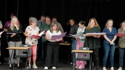 Scripts in hand, they take the stand, rehearsing dreams just as planned Stock Footage 312334894