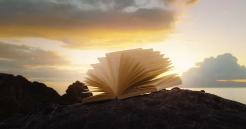 Scriptures on pages of open book at sunset. Rocky lifeless planet. In the Stock Footage 247669068