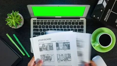 The scriptwriter works with storyline. Black table and laptop with green screen 스톡 동영상 77701364