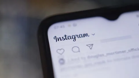 Scroll instagram social network by meta app on a blur night city. Stock Footage 232991765