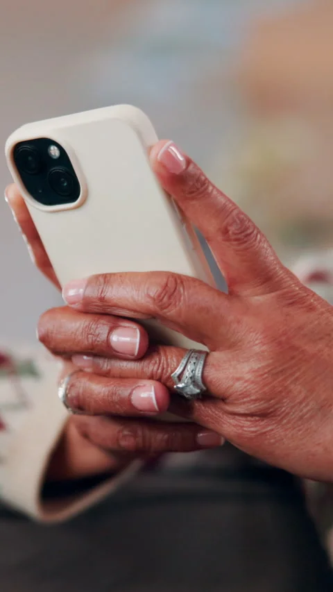 Scroll, phone and hands of old woman on sofa in home for bingo app, social media Stock Footage 338375335