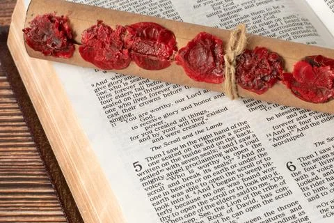 Scroll with seven seals on open holy bible book of revelation, close-up Stock Photos