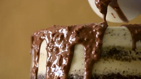 Scroll through the cake. Pouring chocolate sauce with nuts over the rainbow cake Stock Footage 148391706
