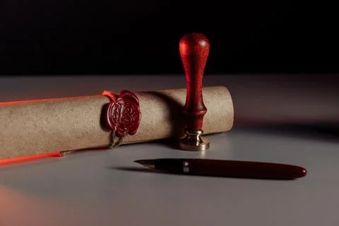 Scroll with wax seal stamp on a table Stock Photos