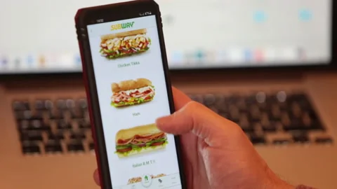Scrolling and typing 'subway' Fast food app on Android mobile phone Stock Footage 146909645