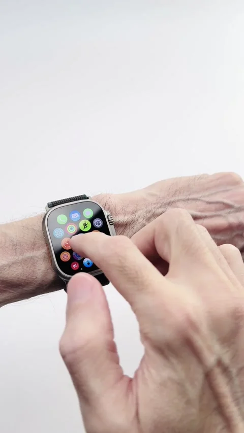 Scrolling app icons on an Apple Watch Ultra wearable computer - illustrative Stock Footage 313019861