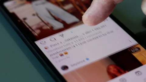Scrolling Beyonce's Instagram profile page on a Smartphone. Stock Footage 245433076