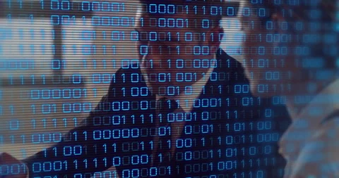 Scrolling binary digits on desk, man writing notes; colleague marking documents Stock Footage 312655657