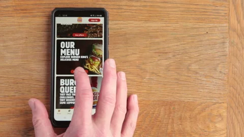 Scrolling Burger King menu on android phone in the time of Covid in the UKK Stock Footage 147264862